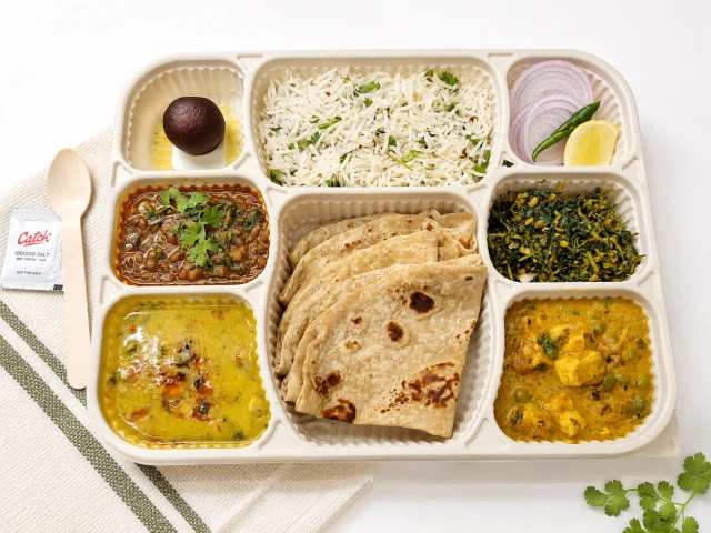 Tiffinzo Signature Thali with rotis, rice, vegetable dishes and accompaniments